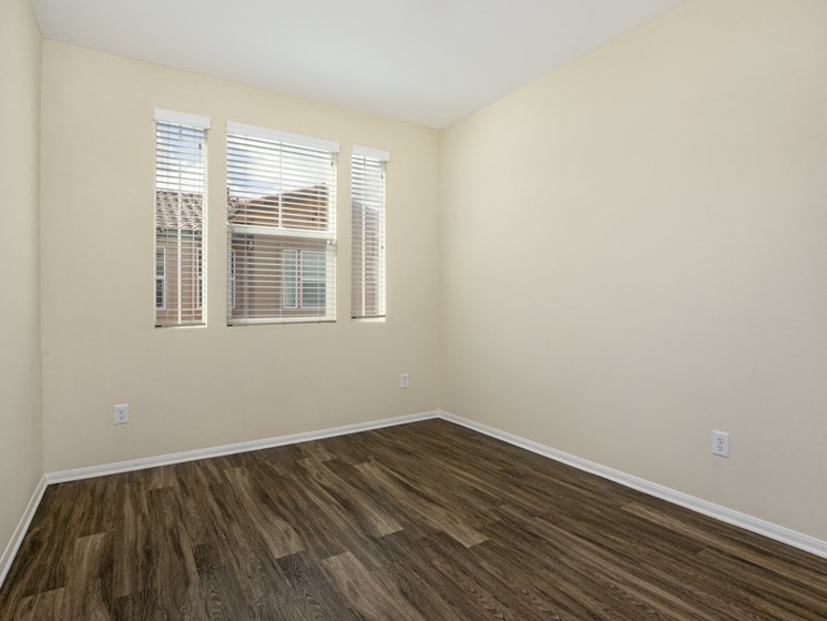 Parkside Villas unfurnished bedroom with wooden floors and window